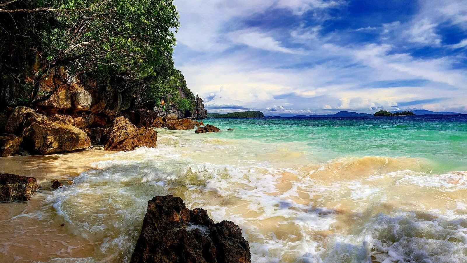 A rocky cove with turquoise water on Dinagat Island in the Caraga region, Philippines