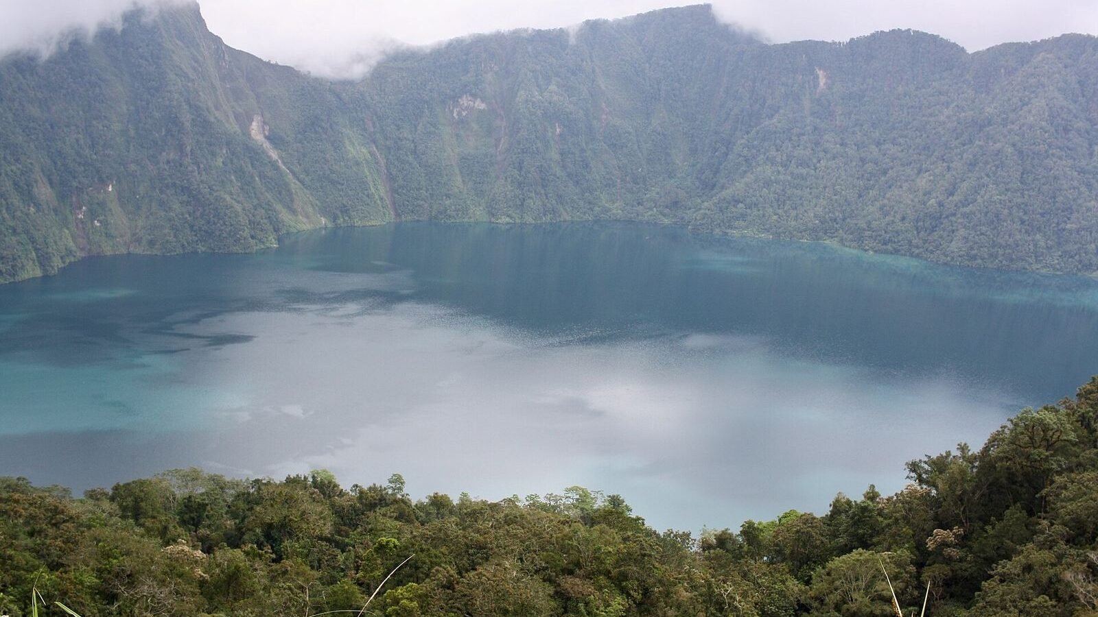 The crater lake of Lake Holon ringed by steep forested walls in T'boli, South Cotabato, Philippines