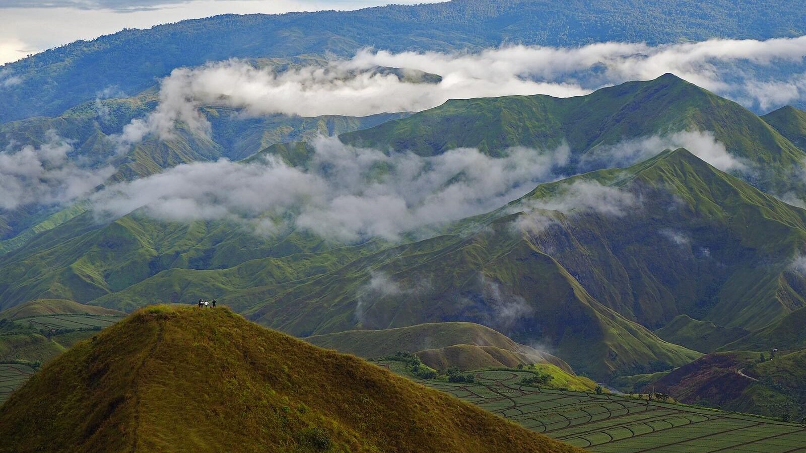 Cloud drifting over the green slopes of Panimahawa Ridge in Impasug-ong, Bukidnon, Philippines