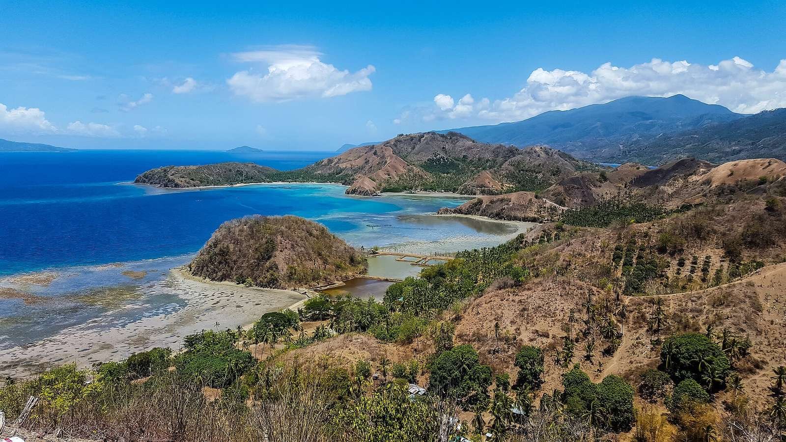 The Sleeping Dinosaur headland above the turquoise water of Pujada Bay at Mati, Davao Oriental, Philippines