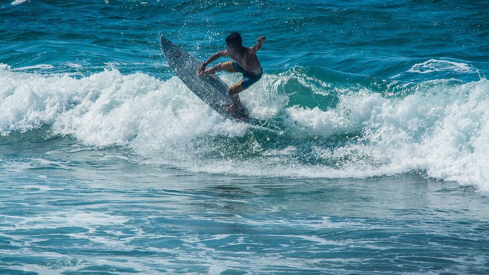 A surfer riding a breaking wave off San Juan, La Union, known as the surfing capital of the northern Philippines
