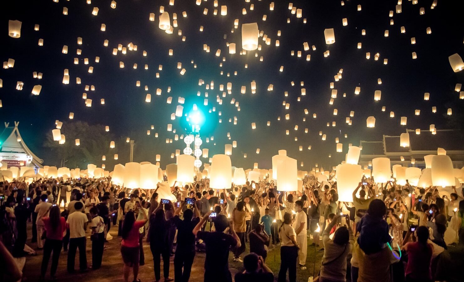 Crowds releasing paper sky lanterns at the Yi Peng lantern festival in Chiang Mai, Thailand